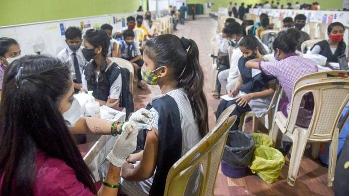 A health worker administers a dose of Covid-19 vaccine to a teenager, at Jumbo Covid-19 Vaccination Centre at Dahisar, in Mumbai. Credit: PTI Photo