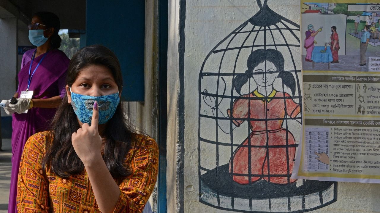 A first-time voter shows her inked marked finger after casting vote at a polling station during the 6th phase of the West Bengal's state legislative Assembly elections on the outskirts of Chopra in North Dinajpur district on April 22, 2021. Credit: AFP File Photo