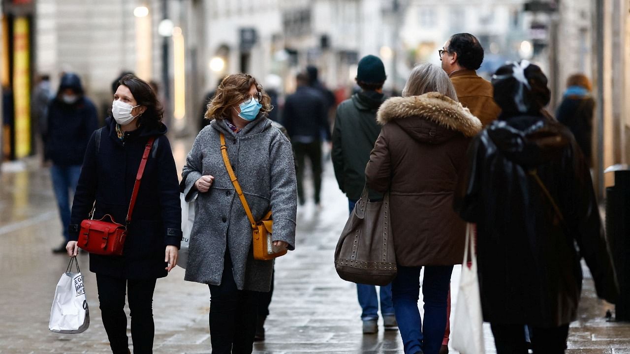 People wearing protective face masks walk on a street, amid the coronavirus outbreak, in Nantes, in France. Credit: Reuters photo