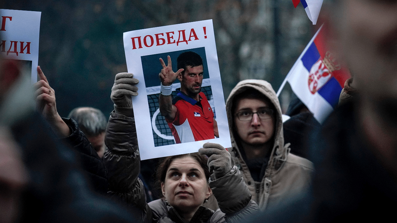 A woman holds a placard reading "Victory!", during a rally in front of Serbia's National Assembly, in Belgrade. Credit: AFP Photo