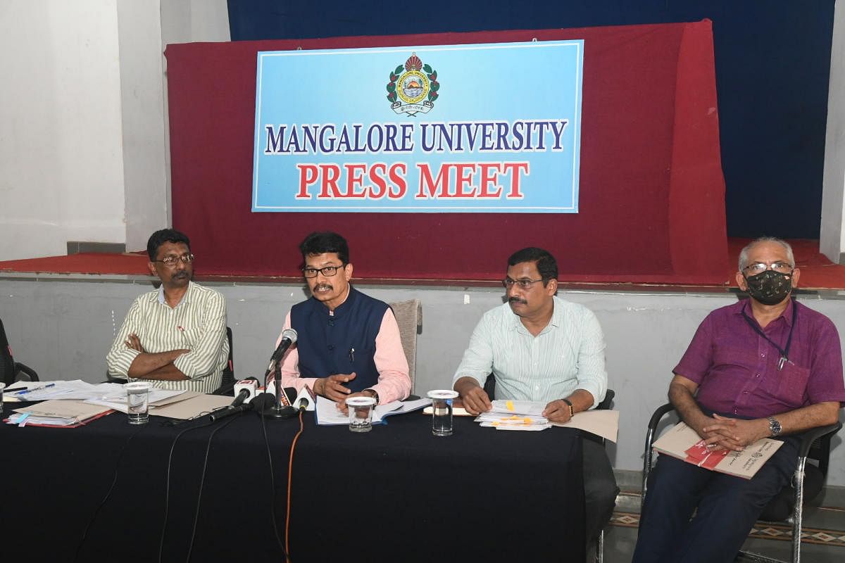 Mangalore University Vice Chancellor Prof P S Yadapadithaya speaks to reporters in Mangaluru.