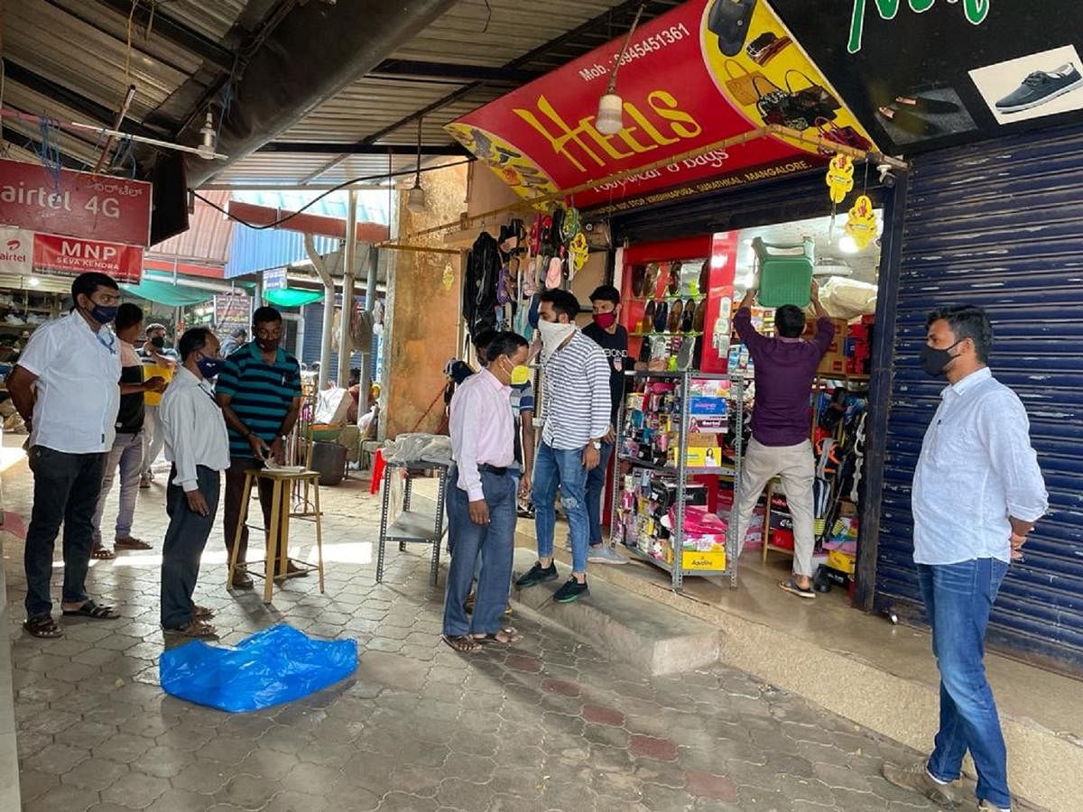 Mangaluru City Corporation officials force a shop to close down during an inspection drive conducted in MCC limits on Saturday.