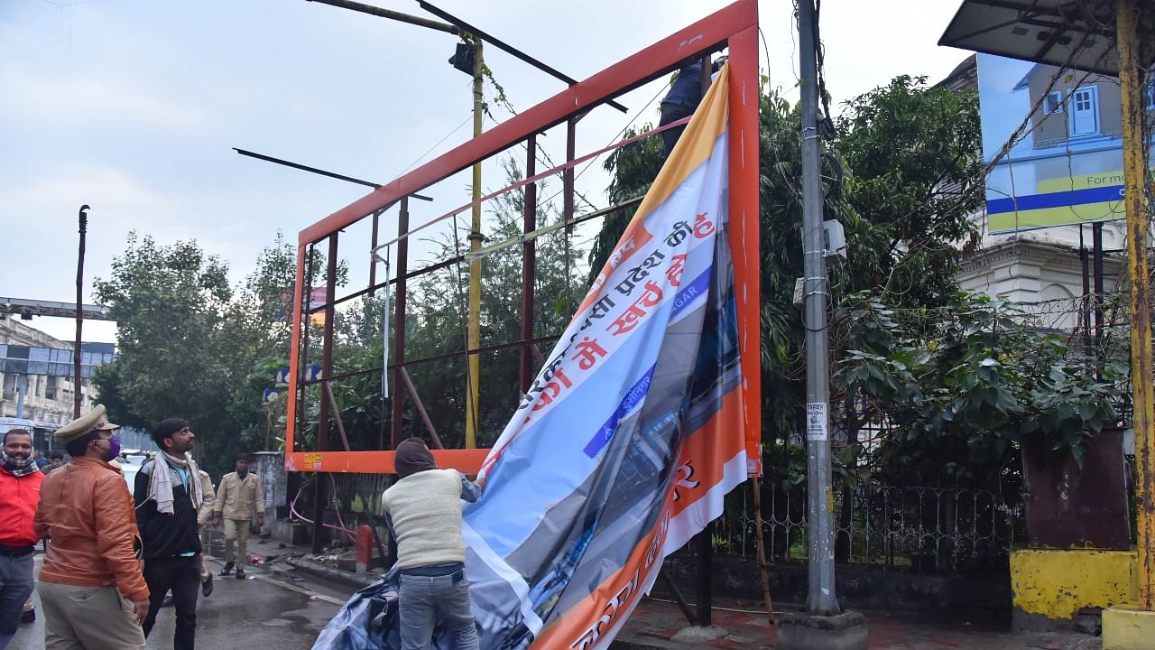 Authorities remove political posters in UP after the model code of conduct came into effect. Credit: PTI Photo
