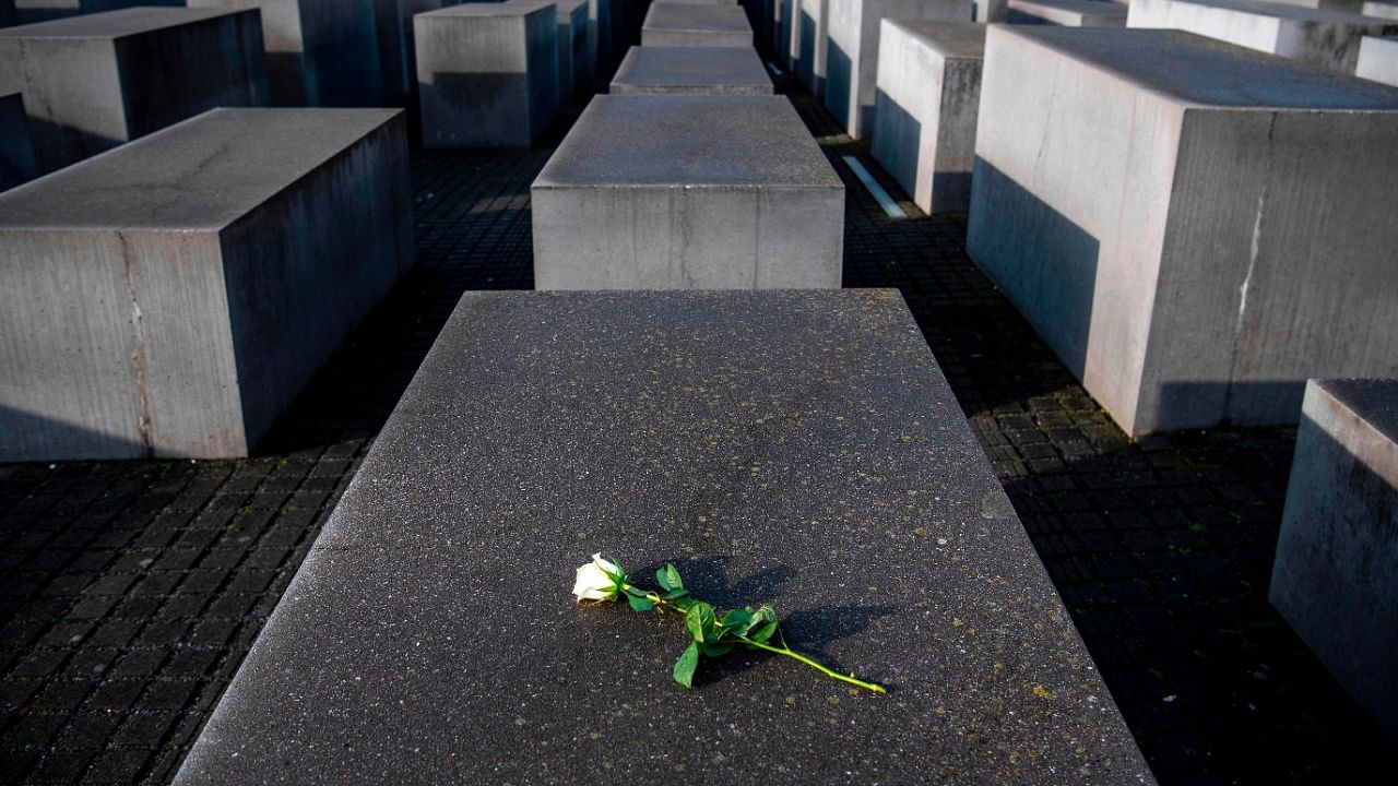 This file photo taken on January 27, 2020 shows a rose lying on one of the concrete steles of the Memorial to the Murdered Jews of Europe (Holocaust memorial) in Berlin, to commemorate the 75th anniversary of the liberation by Soviet troops of the Auschwitz-Birkenau concentration camp in Poland. Credit: AFP File Photo