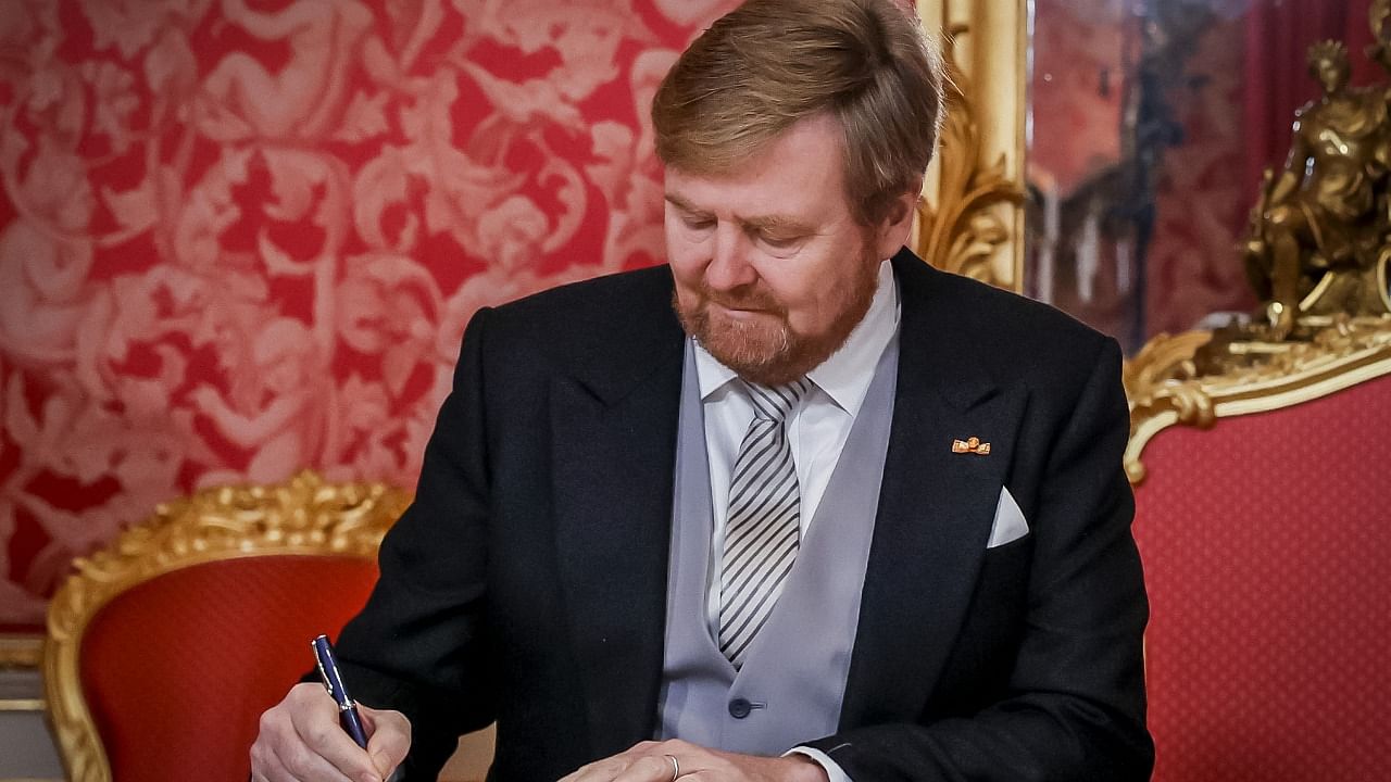 King Willem-Alexander sign the Royal Decrees. Credit: AFP Photo