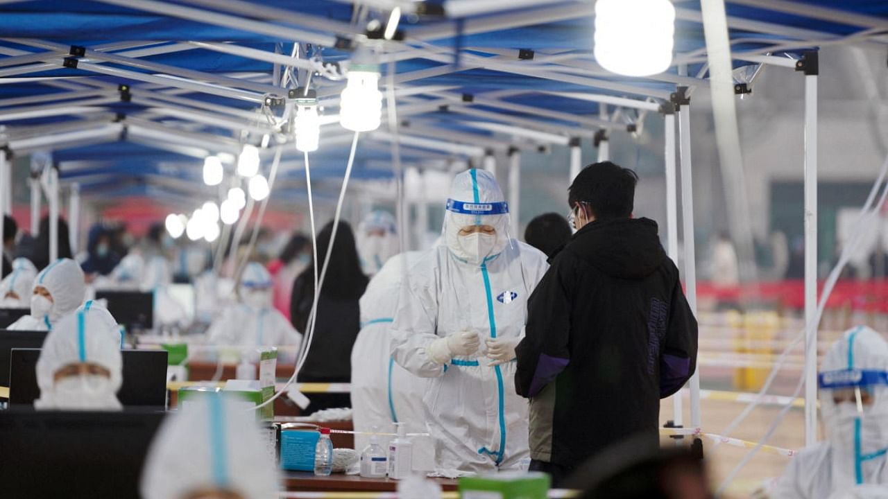 Medical workers in protective suits collect swabs for nucleic acid testing at Northwestern Polytechnical University, which has been placed under a lockdown following the coronavirus disease (Covid-19) outbreak in Xian, Shaanxi province, China. Credit: Reuters Photo