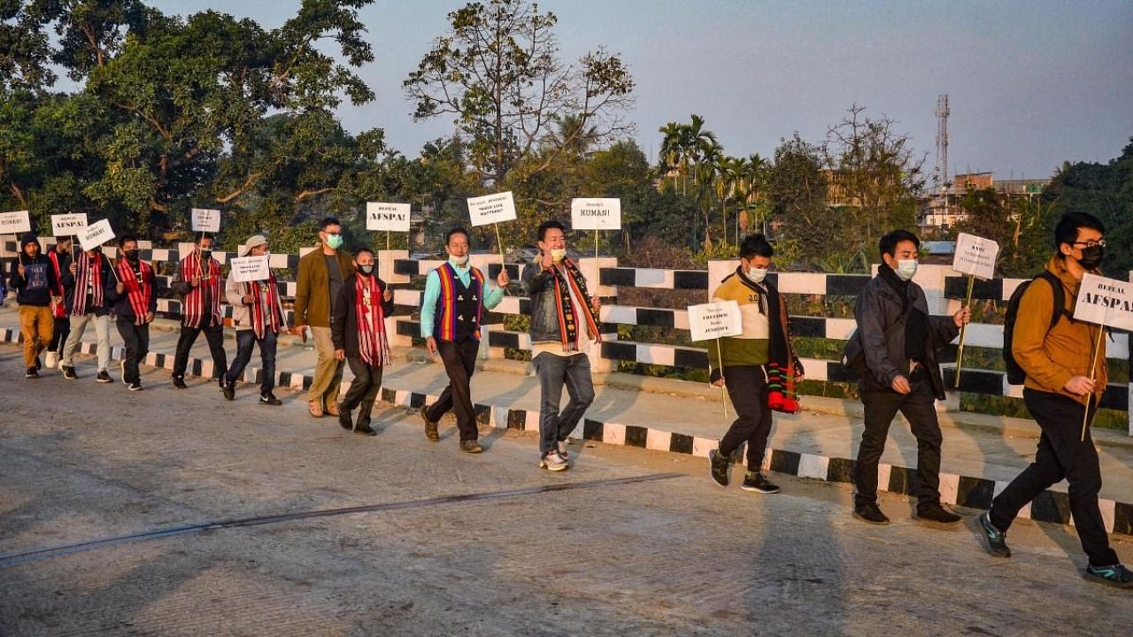 Activists hold a placard as they participate in a protest march to repeal Armed Forces (Special Powers) Act, in Dimapur. Credit: PTI Photo