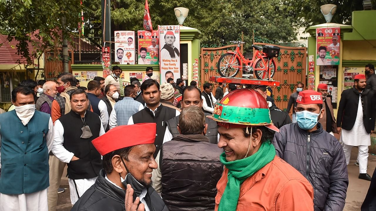 Samajwadi Party workers are seen outside the party office ahead of the 2022 UP Assembly Elections, in Lucknow. Credit: PTI Photo