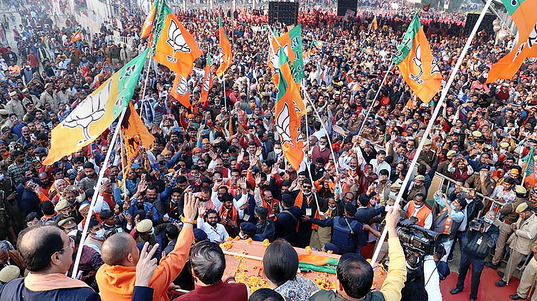 Uttar Pradesh Chief Minister Yogi Adityanath waves towards supporters during the 'Jan Vishwas Yatra' ahead of the upcoming Uttar Pradesh Assembly election. Credit: PTI Photo