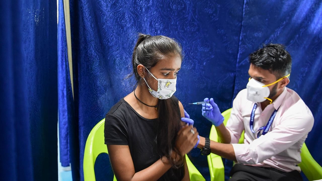 A health worker administers a dose of Covid-19 vaccine to a teenager, in Mumbai. Credit: PTI Photo