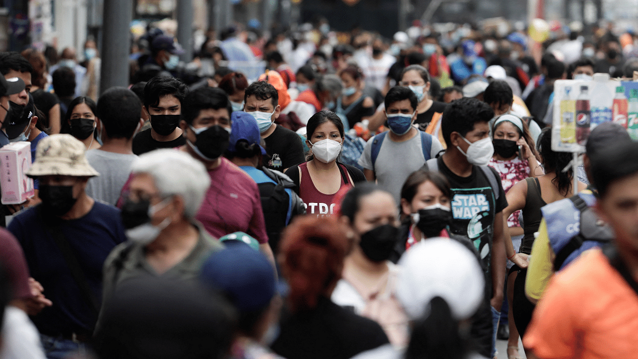 People walk in a crowded street as new cases of the coronavirus disease, driven by the Omicron variant, are surging. Credit: Reuters Photo