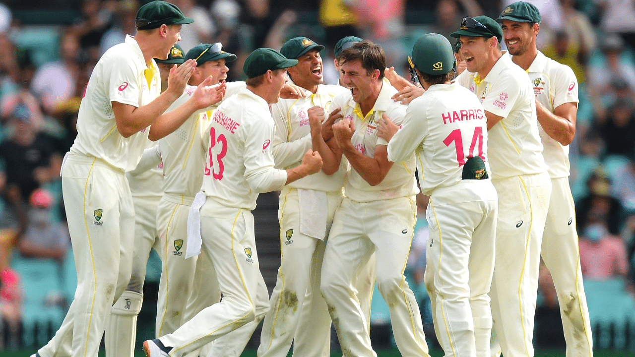 Australia's Pat Cummins celebrates with teammates. Credit: Reuters Photo