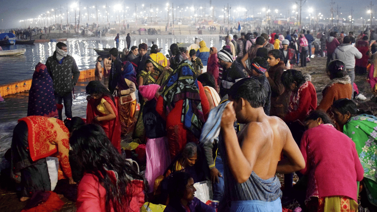 Devotees gather on the banks of Ganga river to take a 'holy dip' on the occasion of 'Makar Sankranti' during the ongoing 'Magh Mela' festival at Sangam. Credit: PTI Photo