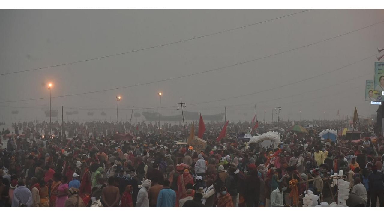 A large gathering of pilgrims gather on a beach for a 'holy dip' in the Ganga river on the occasion of 'Makar Sankranti', during the Gangasagar Mela in South 24 Parganas district of West Bengal. Credit: PTI Photo