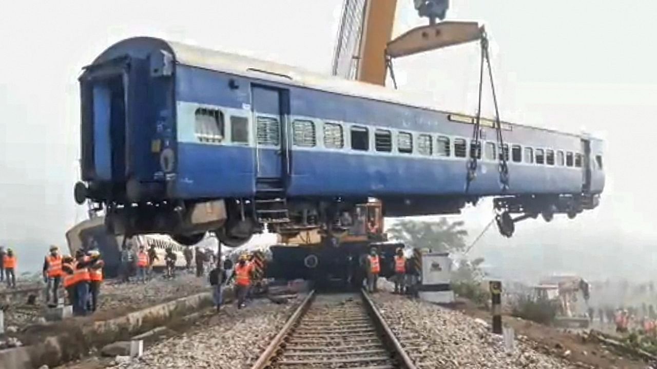  A crane is used to lift mangled remains of Guwahati-Bikaner Express train after it got derailed at Mainaguri in Jalpaiguri district. Credit: PTI Photo
