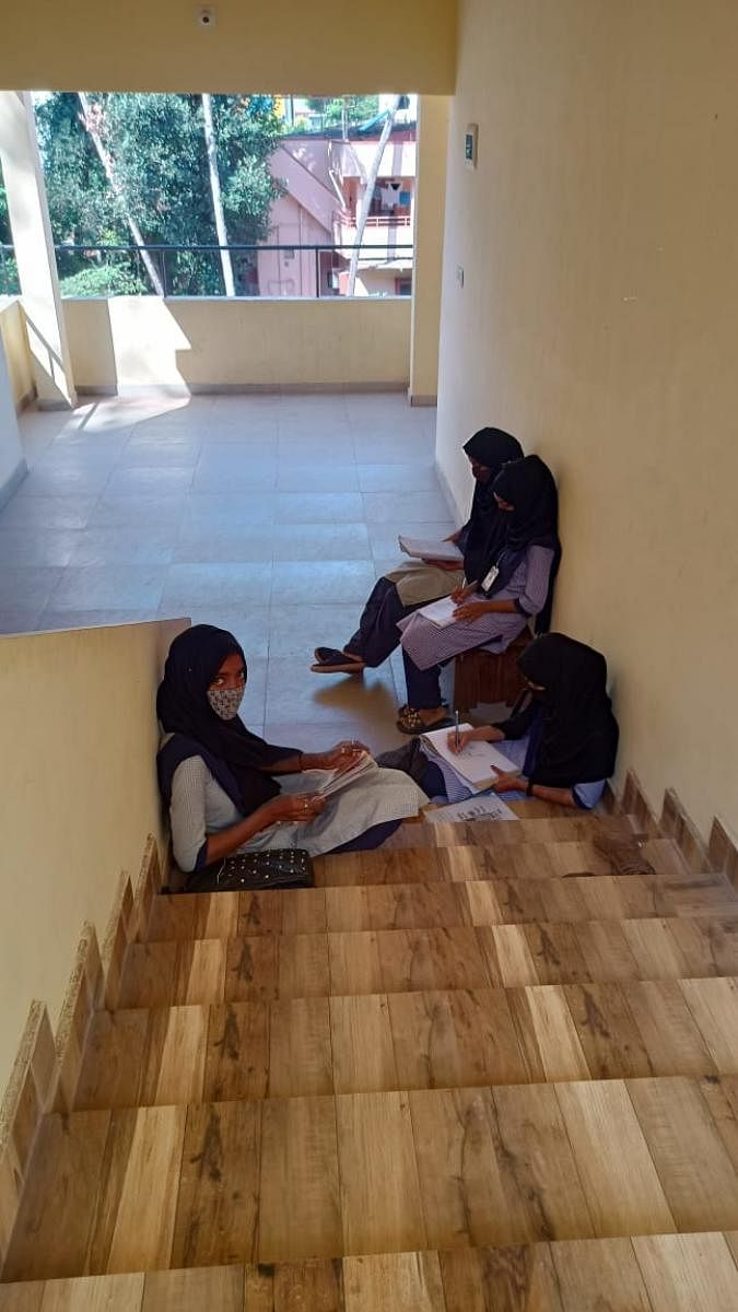 For a fortnight six Muslim students who insisted on wearing Hijab in classrooms have been forced to listen to teaching outside the classrooms at Government Women’s PU College in Udupi.