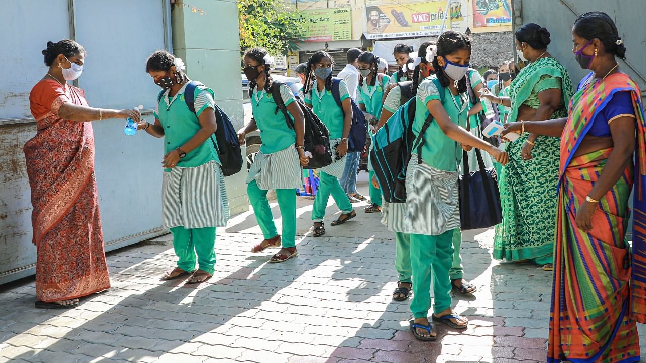 A file photo of school students sanitising their hands in Thoothukudi, Tamil Nadu. Credit: PTI Photo