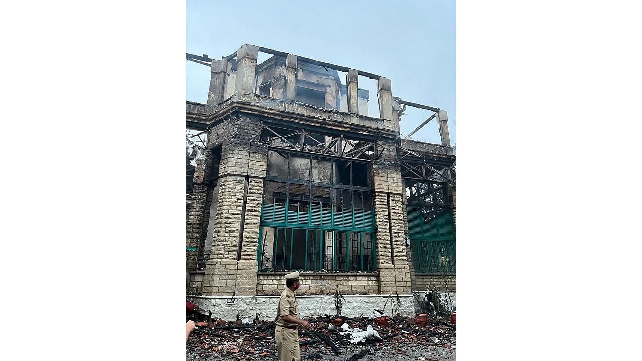 A police person walks past the heritage Secunderabad Club building which was gutted in a major fire, Hyderabad district. Credit: PTI Photo