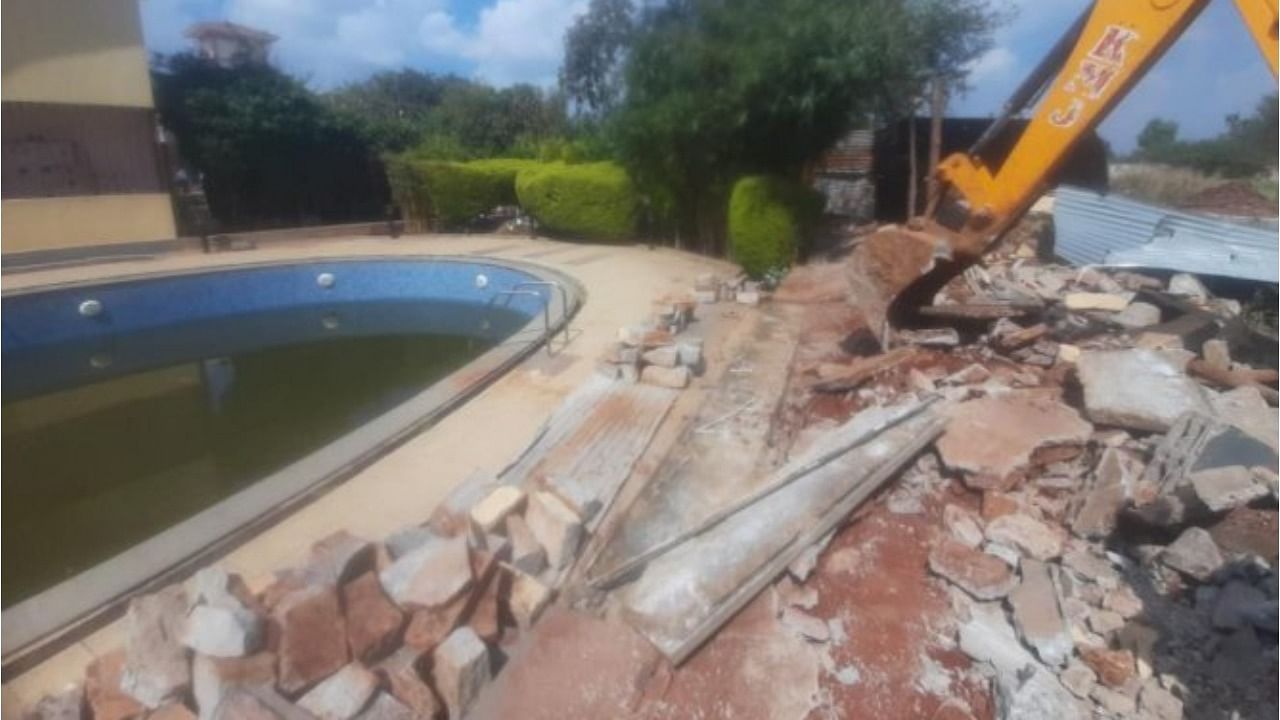 A swimming pool built on government land in Hennagara Rajapura near Jigani is being torn down. Credit: Special Arrangement
