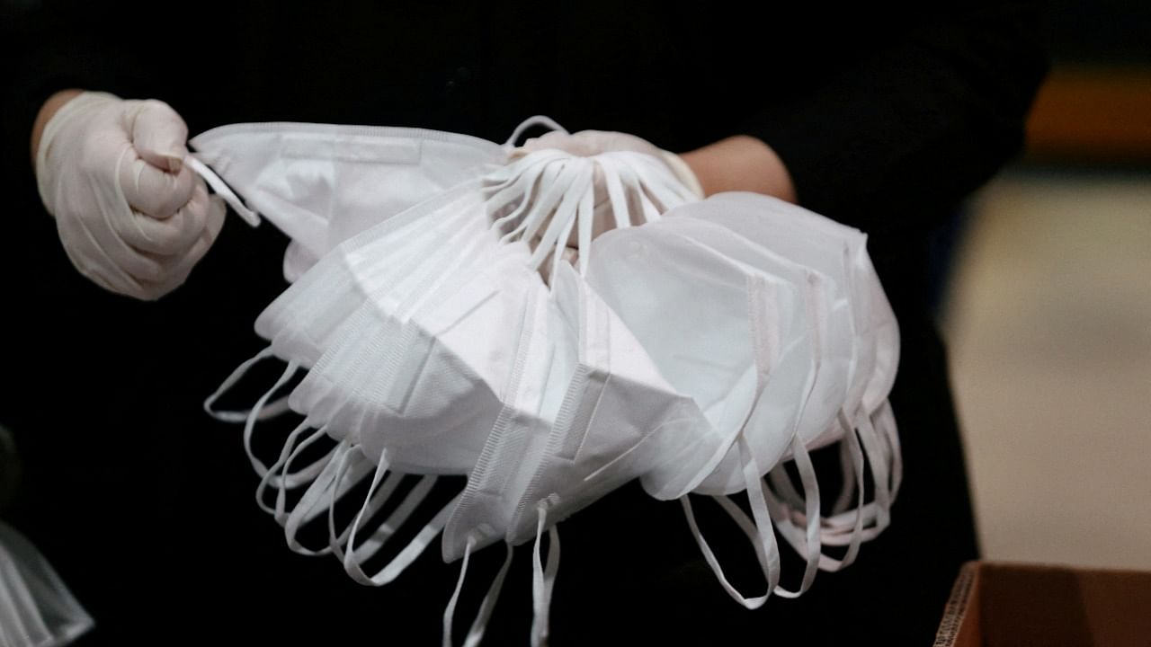 A worker sorts through N95 masks at a production line in UAE. Credit: Reuters Photo