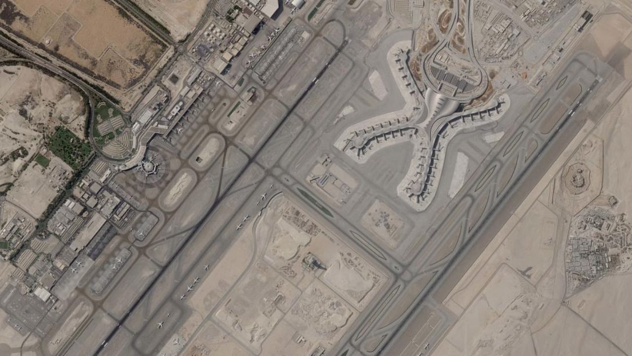 In a satellite photo by Planet Labs PBC, Abu Dhabi International Airport is seen Dec. 8, 2021. A suspected drone attack by Yemen's Houthi rebels targeting a key oil facility in Abu Dhabi killed three people and sparked a separate fire at Abu Dhabi's international airport on Monday, Jan. 17, 2022, police said. Credit: AP/PTI Photo