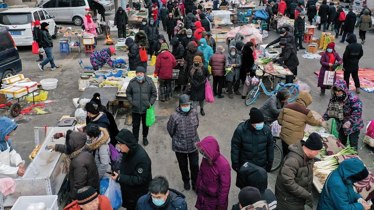 Residents visit a market in Shenyang in China's northeastern Liaoning province on January 12, 2022. Credit: AFP File Photo