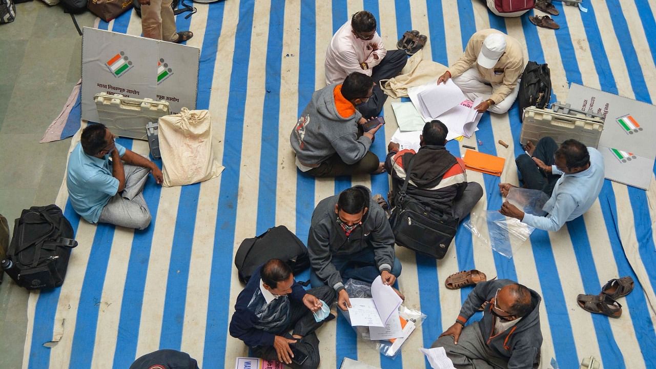 A file photo of polling officials checking EVMs ahead of a Panchayat election in Maharashtra. Credit: PTI File Photo