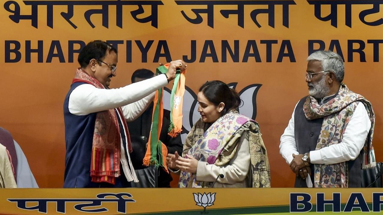 Aparna Yadav, former Uttar Pradesh Chief Minister Mulayam Singh Yadav's daughter-in-law joins BJP in the presence of Uttar Pradesh Deputy Chief Minister Keshav Prasad Maurya (L) and state BJP chief Swatantra Dev Singh (R), at party HQ in New Delhi. Credit: PTI photo