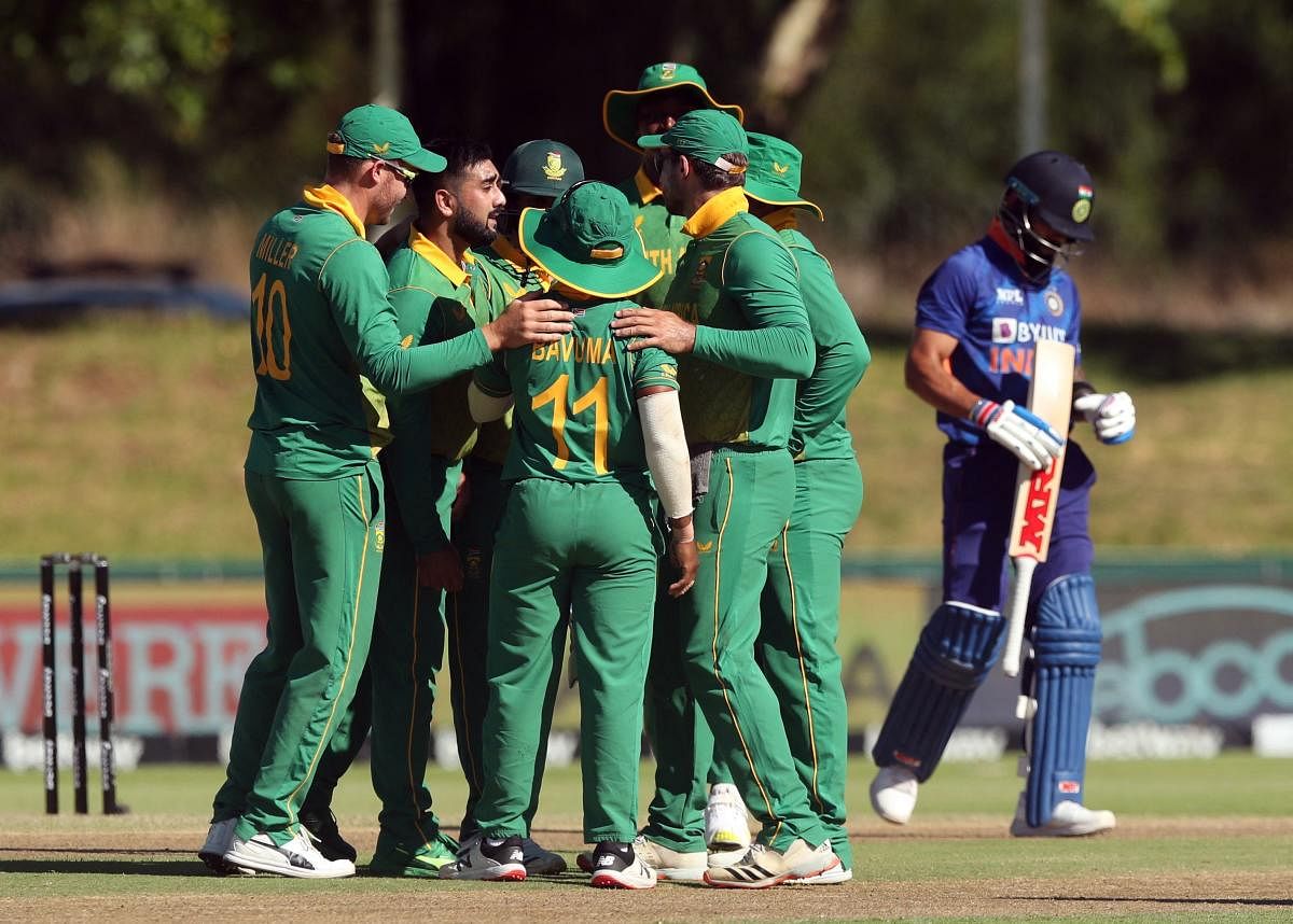South Africa's Tabraiz Shamsi celebrates with teammates after taking the wicket of India's Virat Kohli. Credit: Reuters Photo