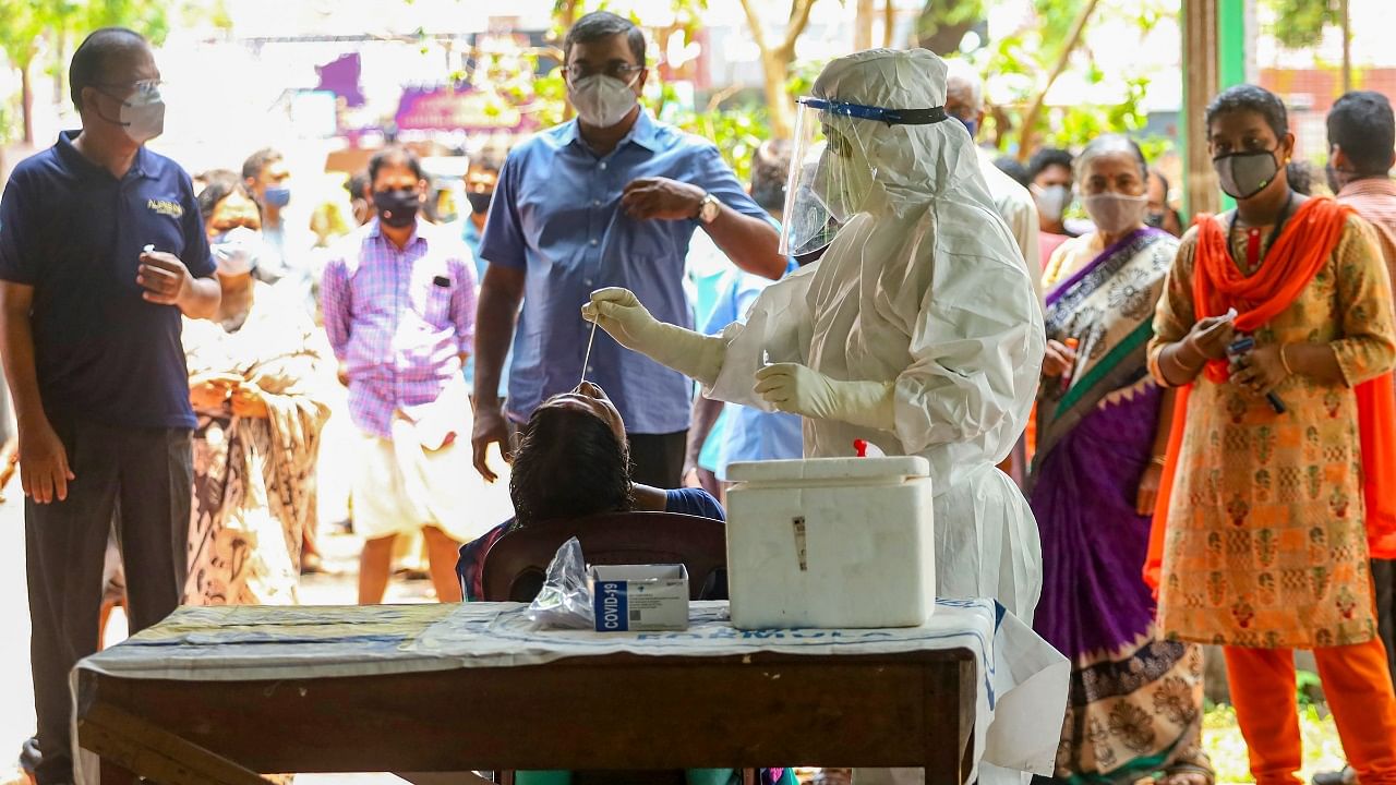 Health workers take swab samples for Covid-19 testing as coronavirus cases surge in Kozhikode. Credit: PTI Photo