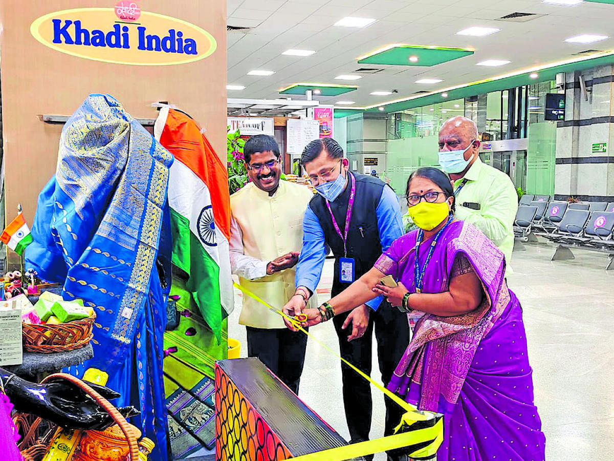 Dharmesh Mehta, terminal in-charge and Jyoti Naik, district officer, Khadi and Village Industries Board, jointly inaugurate the khadi kiosk at Mangaluru International Airport.