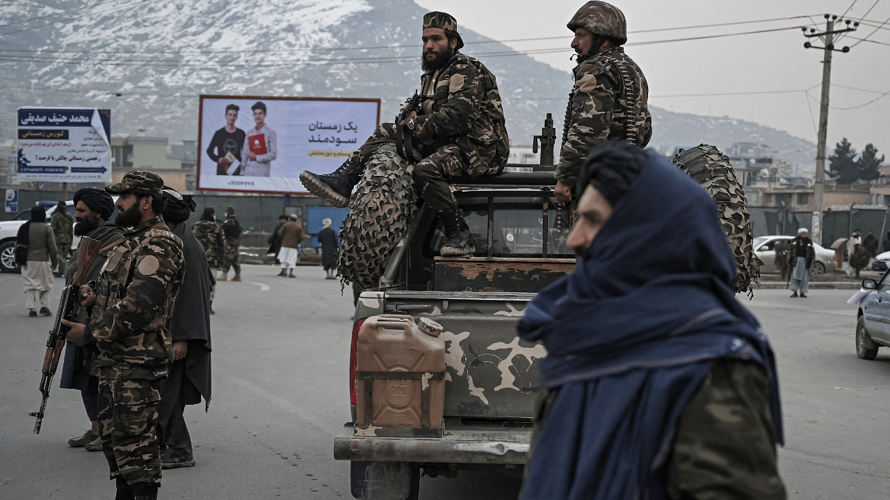 Taliban fighters stand guard. Credit: AFP Photo