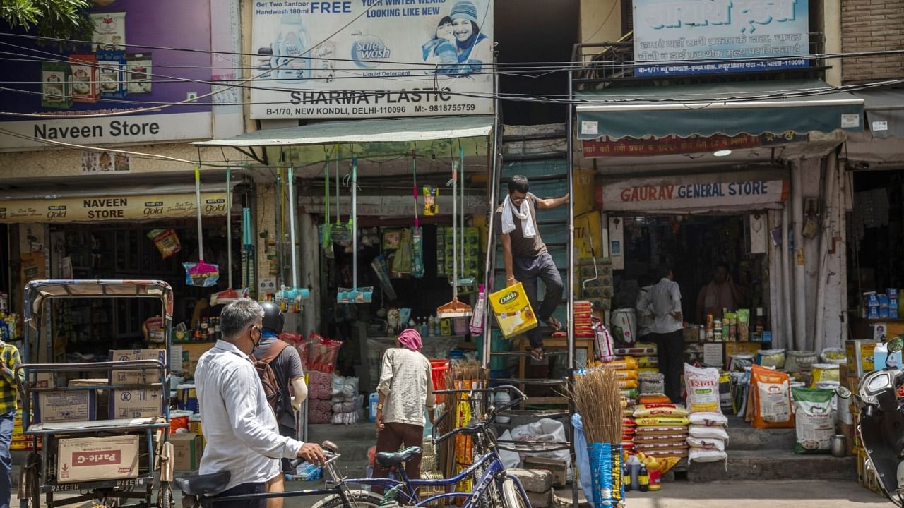 A man carries a box of sunflower oil down a store's flight of stairs at the Kondli Wholesale Market in Noida, Uttar Pradesh, India, on Tuesday, July 14, 2020. India’s wholesale prices fell for a third straight month, signaling muted price pressures in the economy despite retail inflation edging up. Credit: Bloomberg Photo