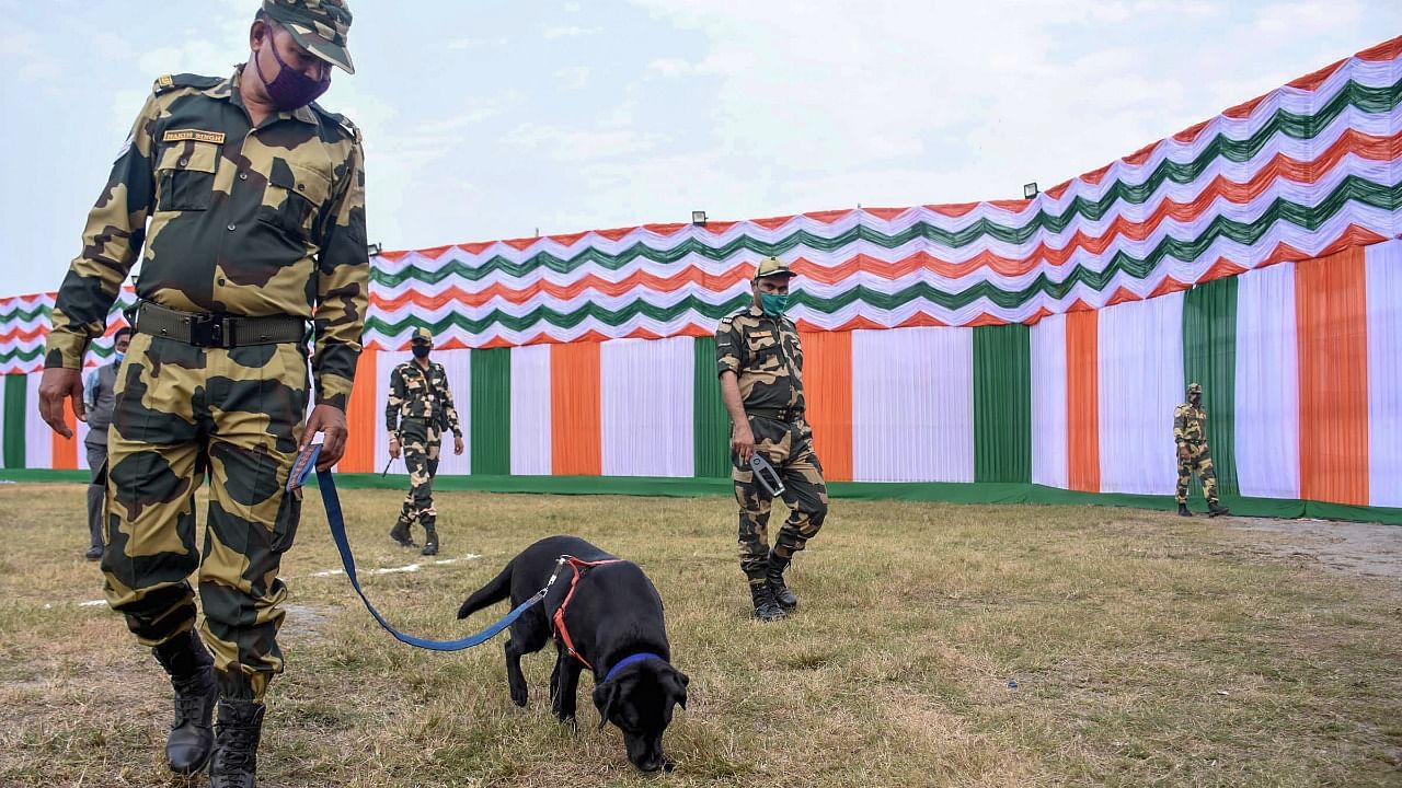 Security personnel with a sniffer dog check for explosives on the eve of Republic Day Parade 2022, in Guwahati. Credit: PTI Photo