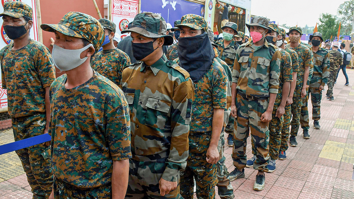 Members of Tiwa Liberation Army (TLA) and United Gorkha Peoples' Organisation (UGPO) militant groups of Assam during the arms laying ceremony. Credit: PTI Photo