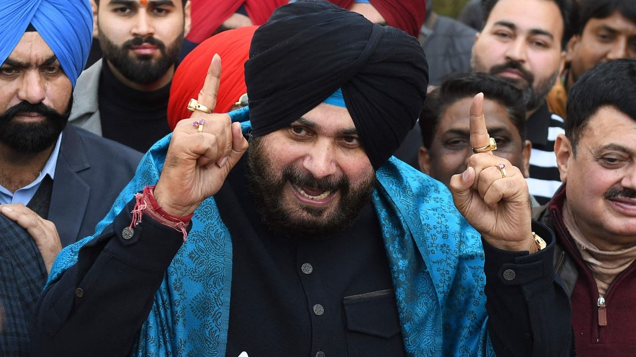 Punjab Congress party president and Congress party candidate Navjot Singh Sidhu (C) along with his supporters gestures as he speaks to the media after filing his nomination papers for the upcoming Punjab state assembly elections, in Amritsar on January 29, 2022. Credit: AFP File Photo