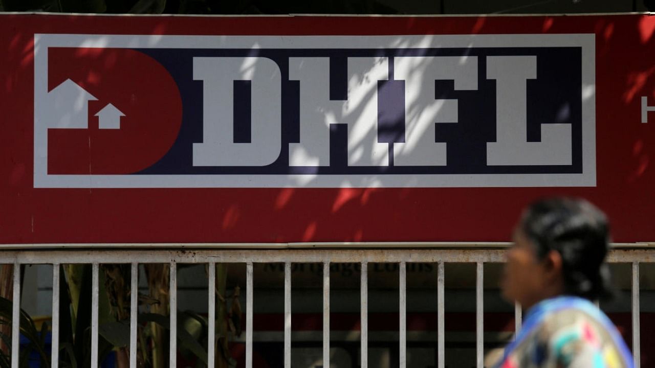 A woman walks past a signboard of Dewan Housing Finance Corporation Ltd. Credit: Reuters Photo