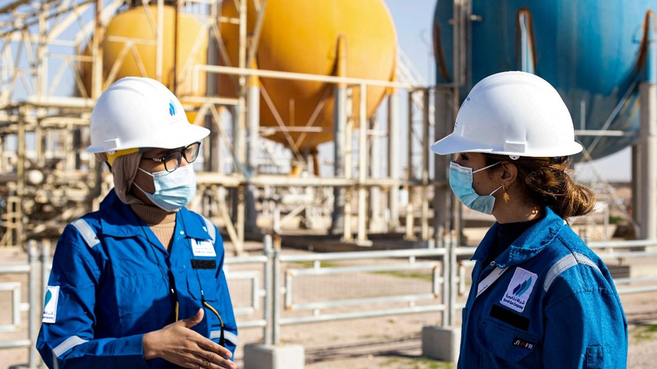 Team leader and oil engineer Safa al-Saeedi (R) in conversation with chemical engineer Dalal Abdelamir, who are among 180 women at the Basrah Gas Company. Credit: AFP Photo