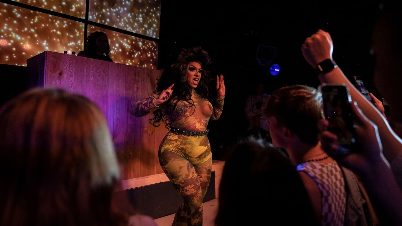 South African drag queen Maxine Wild sings and performs during a show at a LGBTQ+ club in Johannesburg. Credit: AFP Photo