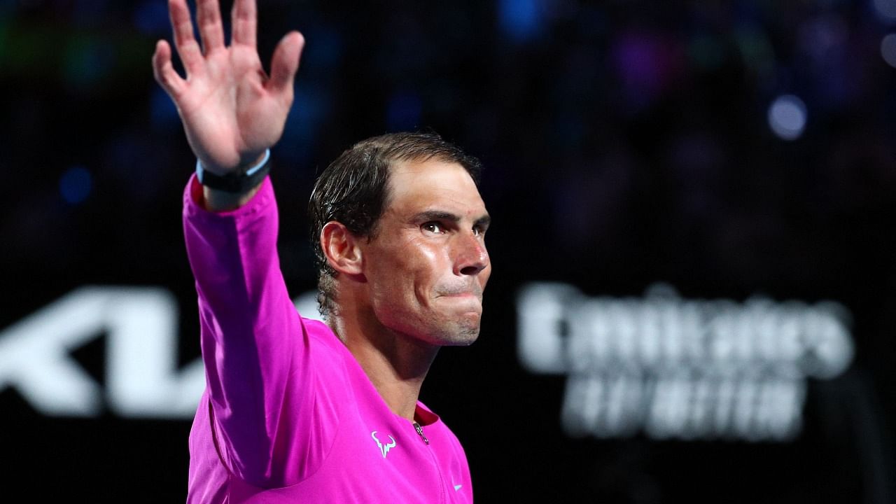 Spain's Rafael Nadal waves during the awards ceremony after winning against Russia's Daniil Medvedev during their men's singles final match on day fourteen of the Australian Open tennis tournament in Melbourne early on January 31, 2022. Credit: AFP Photo