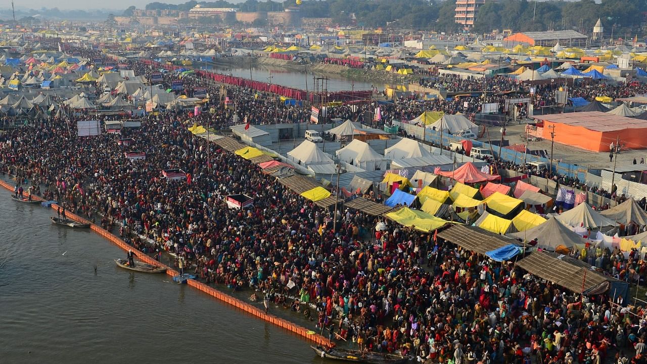 Devotees take a holy dip at Sangam. Credit: AFP Photo