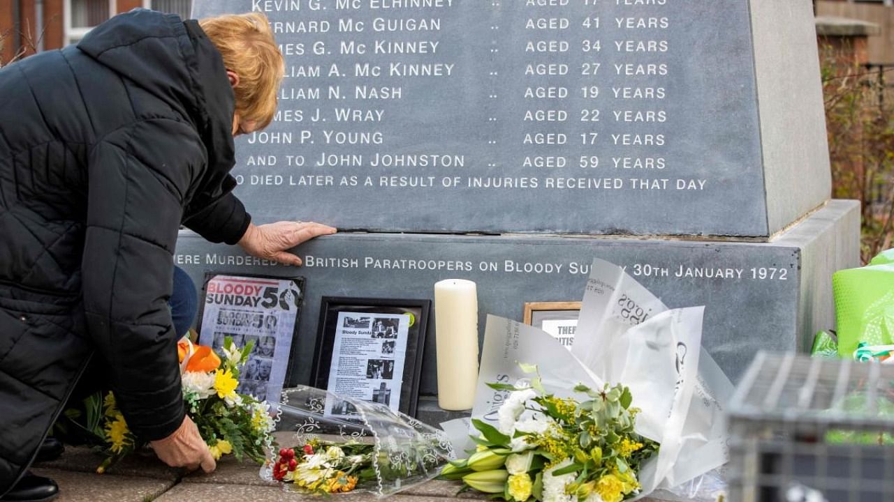 Flowers are picture placed at a memorial engraved with the names of the 13 who died during the 1972 Bloody Sunday killings, and John Johnston who died later, in the Bogside area of Londonderry, (Derry) in Northern Ireland. Credit: AFP Photo