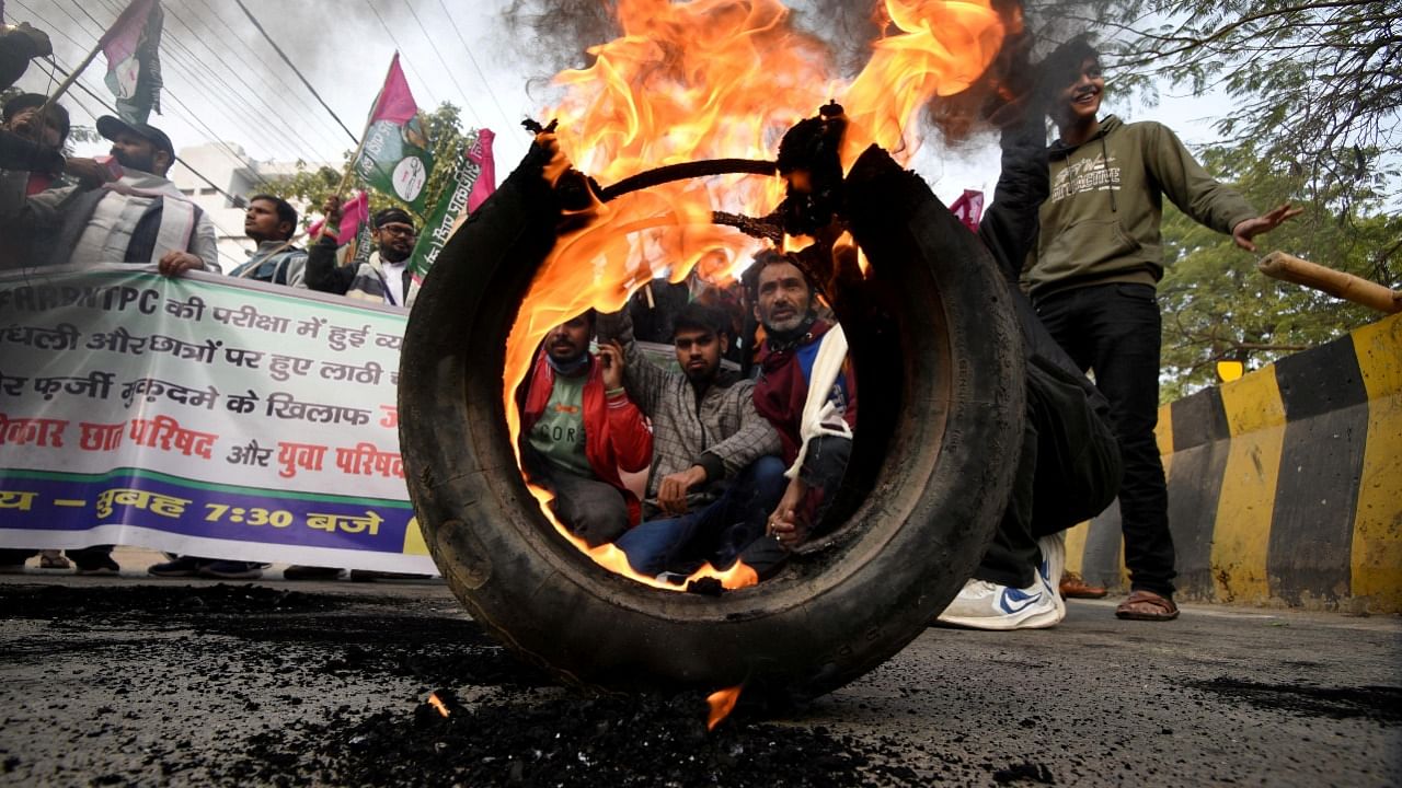 Activists from Jan Adhikar Party burn tyres as they block a road during a strike called by student associations to protest against what they call irregularities in recruitment by the railways department, in Patna, Bihar. Credit: Reuters Photo