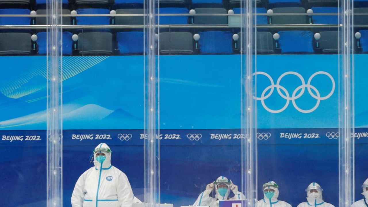 Medical personnel wearing personal protective equipment (PPE) sit rink-side as Czech ice hockey team trains at the National Indoor Stadium ahead of the Beijing 2022 Winter Olympics in Beijing, China, February 1, 2022. Credit: Reuters Photo