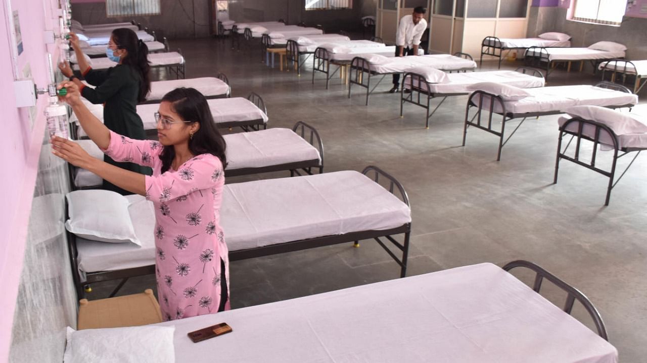 Healthcare workers check oxygen devices and keep ready a Covid isolation ward at Mahalakshmi Layout. Credit: DH file photo/B K Janardhan