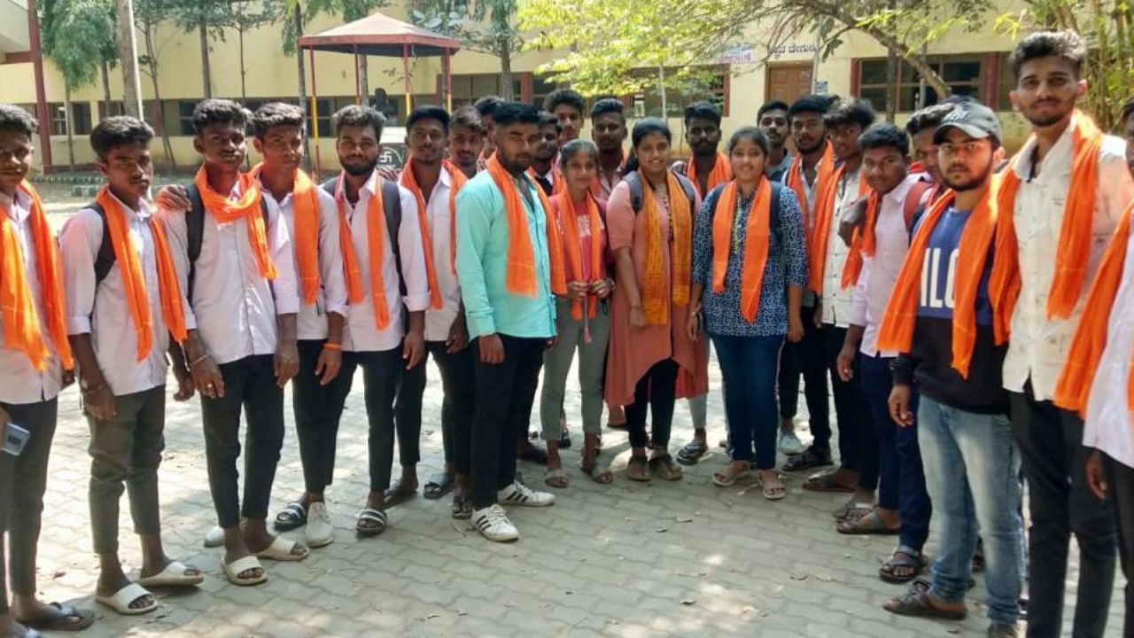 Students wearing saffron scarf in college. Credit: DH Photo