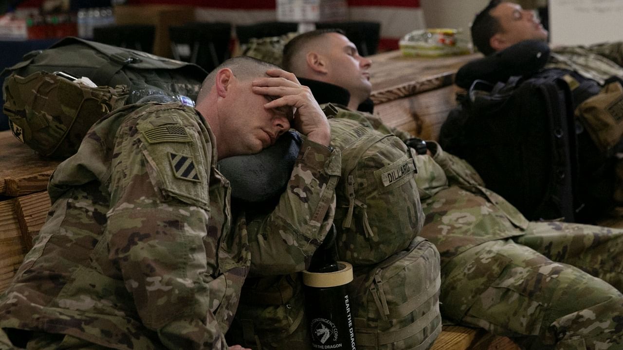 US service members wait at the Pope Army Airfield before deploying to Europe at Fort Bragg. Credit: AFP Photo