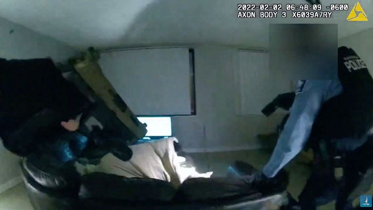 Screen grab showing police pointing their guns at Amir Locke as he lies on a sofa. Credit: AFP Photo