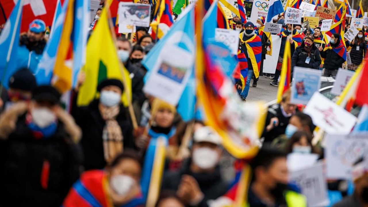 Tibetan protesters take part in a protest march from the International Olympic Committee (IOC) headquarters to the Olympic Museum ahead of the opening of the Beijing 2022 Winter Olympics, in Lausanne. Credit: AFP Photo