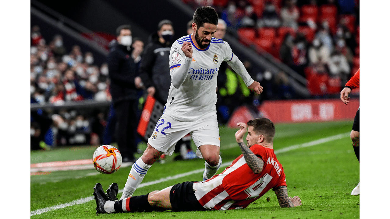 Real Madrid's Isco, left, duels for the ball with Athletic Bilbao's Inigo Martinez during a Spanish Copa del Rey quarter final soccer match between Athletic Bilbao and Real Madrid at the San Mames stadium in Bilbao, Spain. Credit: AP Photo